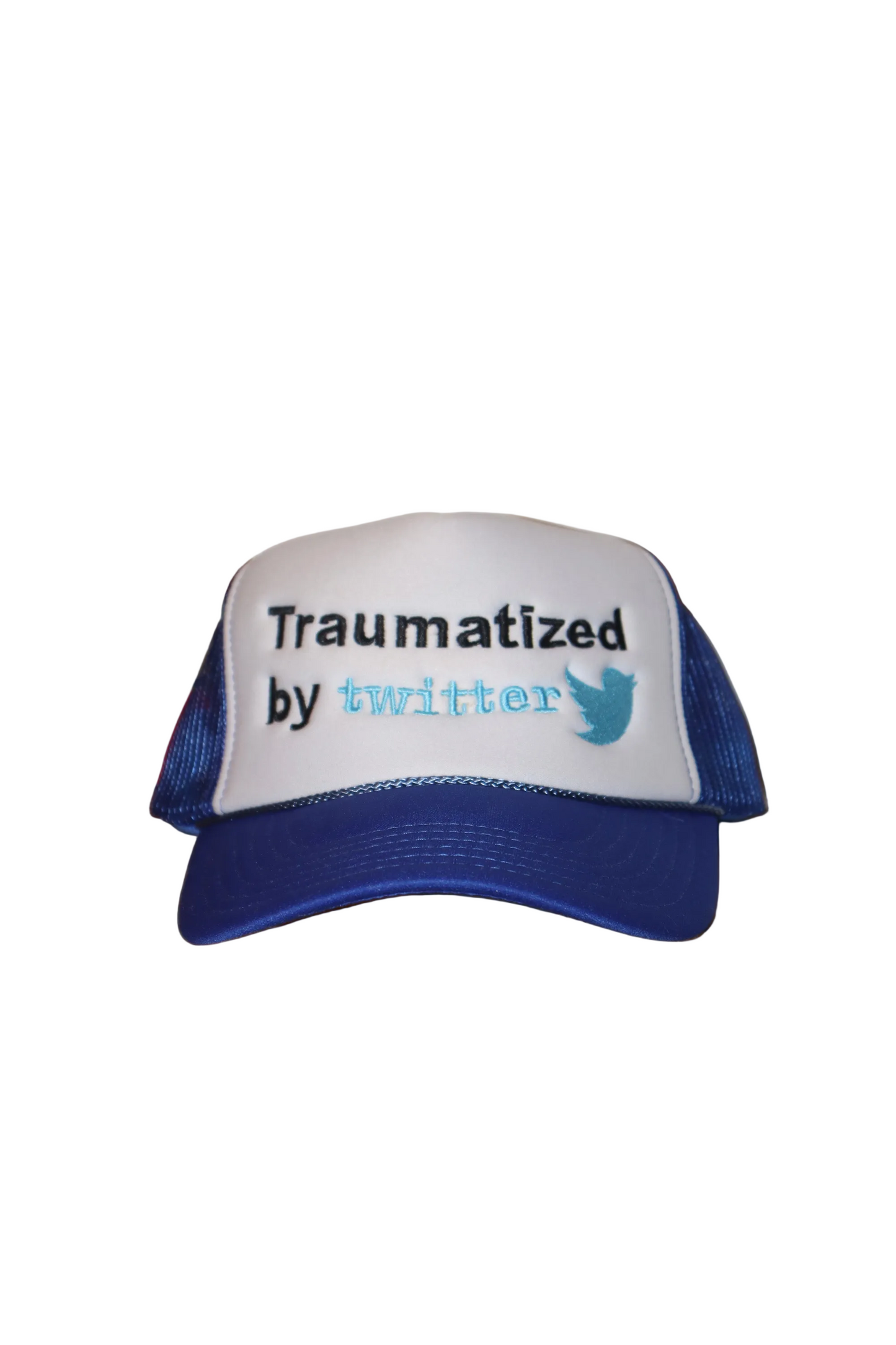 Trucker hat with 'Traumatized by Twitter' text on a wooden surface