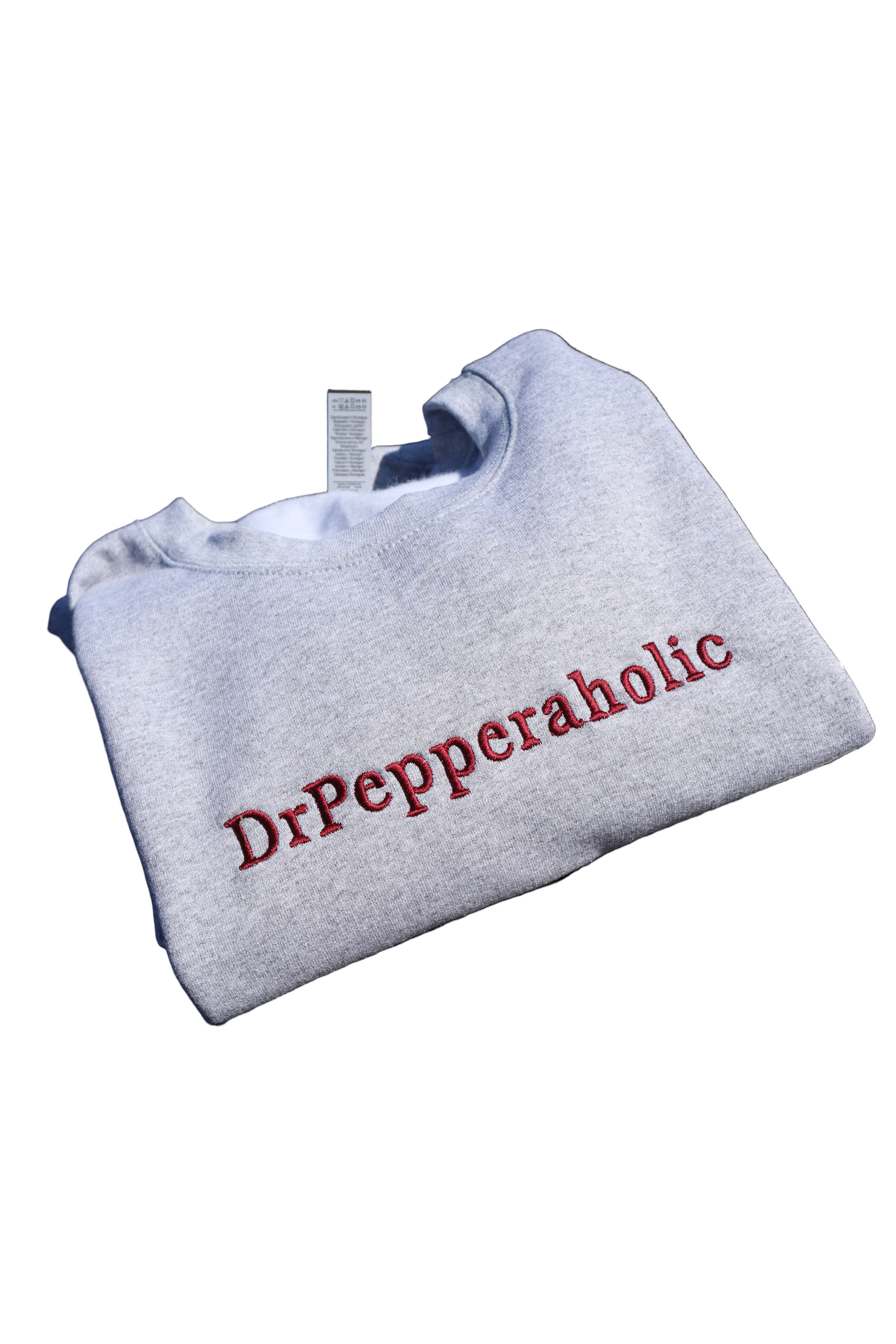 Gray sweatshirt with 'Dr Pepperaholic' text on a white background