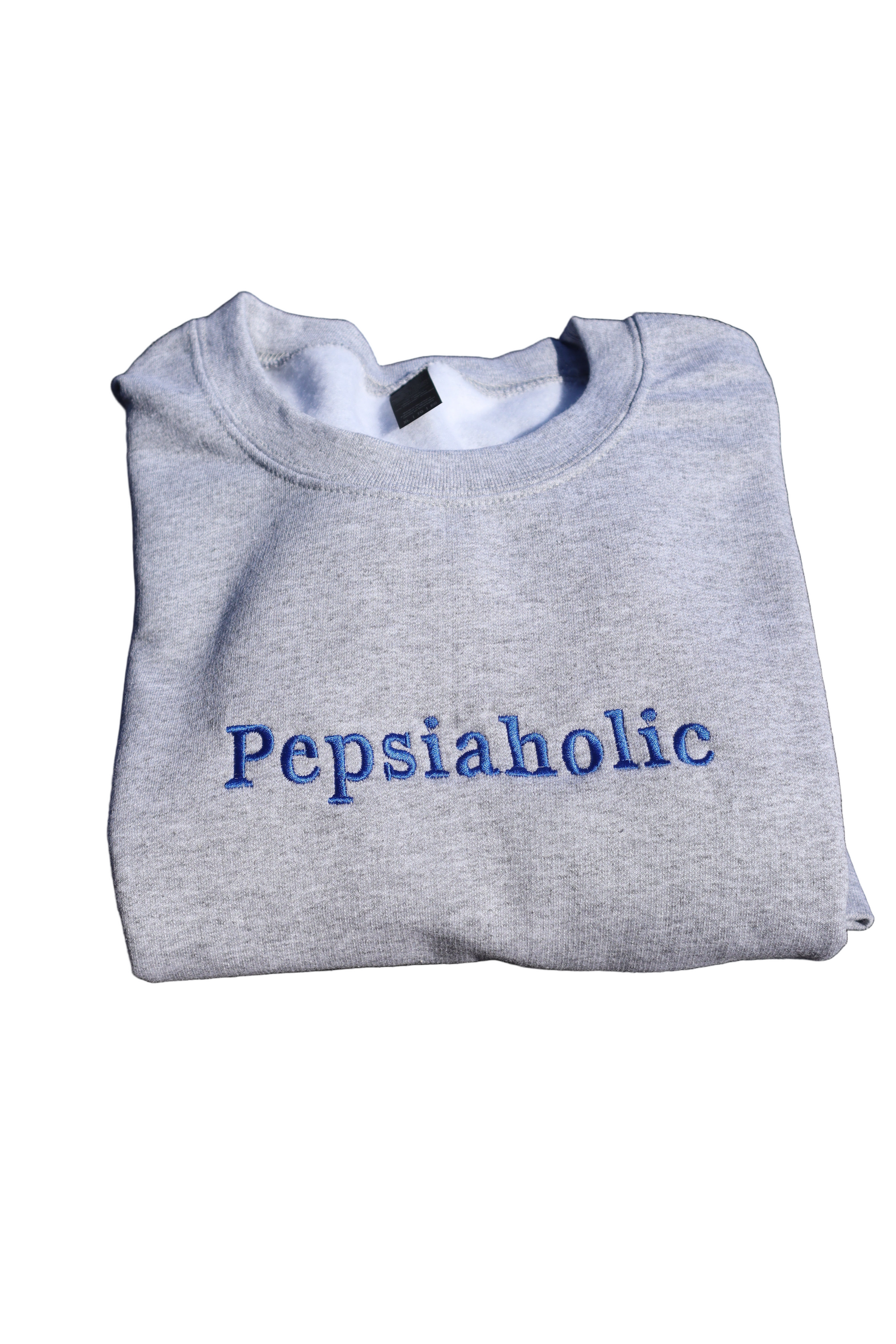 Gray sweatshirt with 'Pepsiaholic' text on a white background