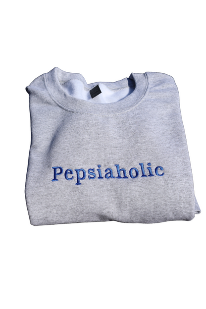 Gray sweatshirt with 'Pepsiaholic' text on a white background