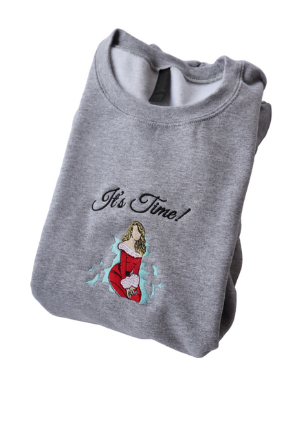 Folded gray sweatshirt with 'It's Time!' text and graphic design on a white background