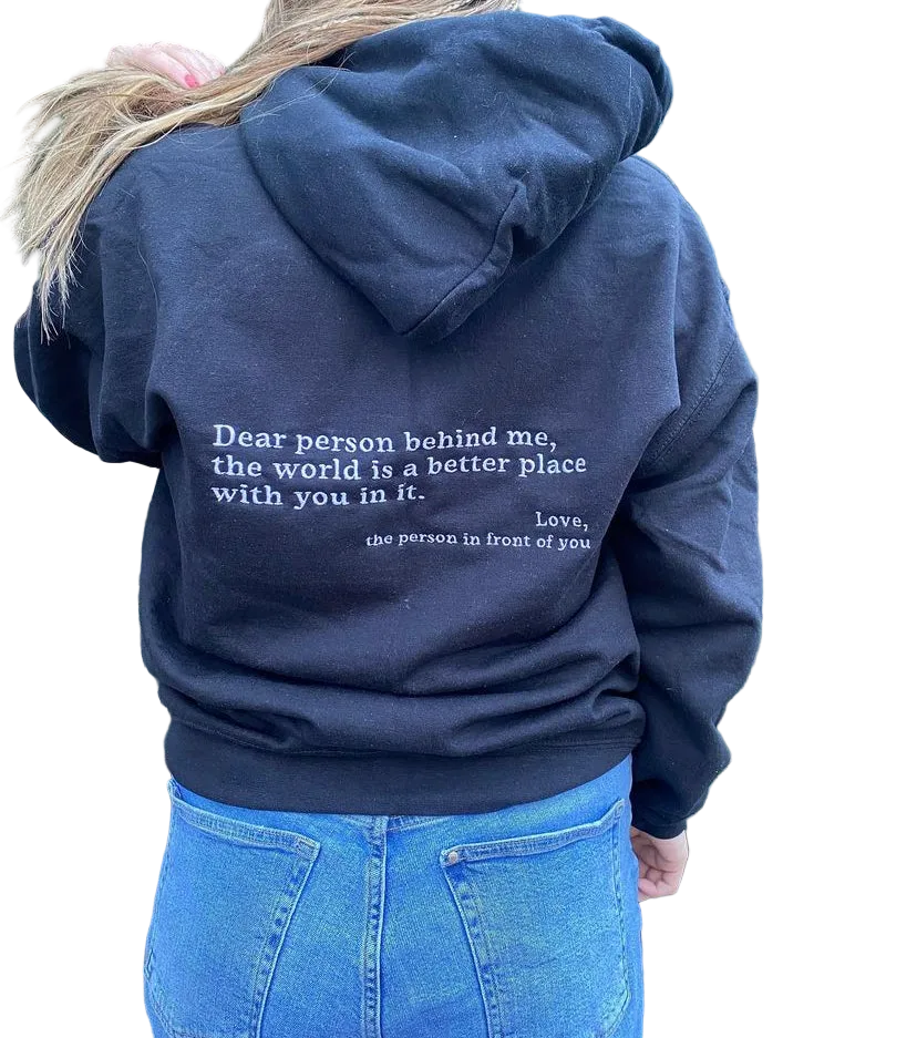 Navy hoodie with a motivational quote on the back, worn by a person.